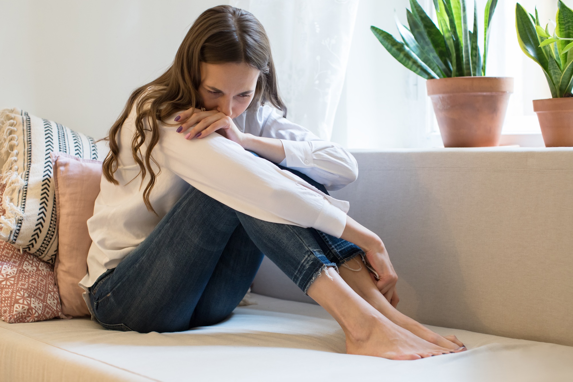 Crying woman in depression, quarrel with husband, holding phone and gets bad news